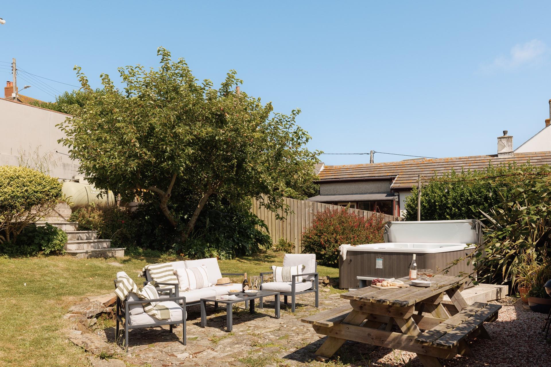 Unwind in the bubbling hot tub with a glass of wine.