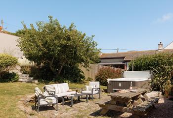 Unwind in the bubbling hot tub with a glass of wine.