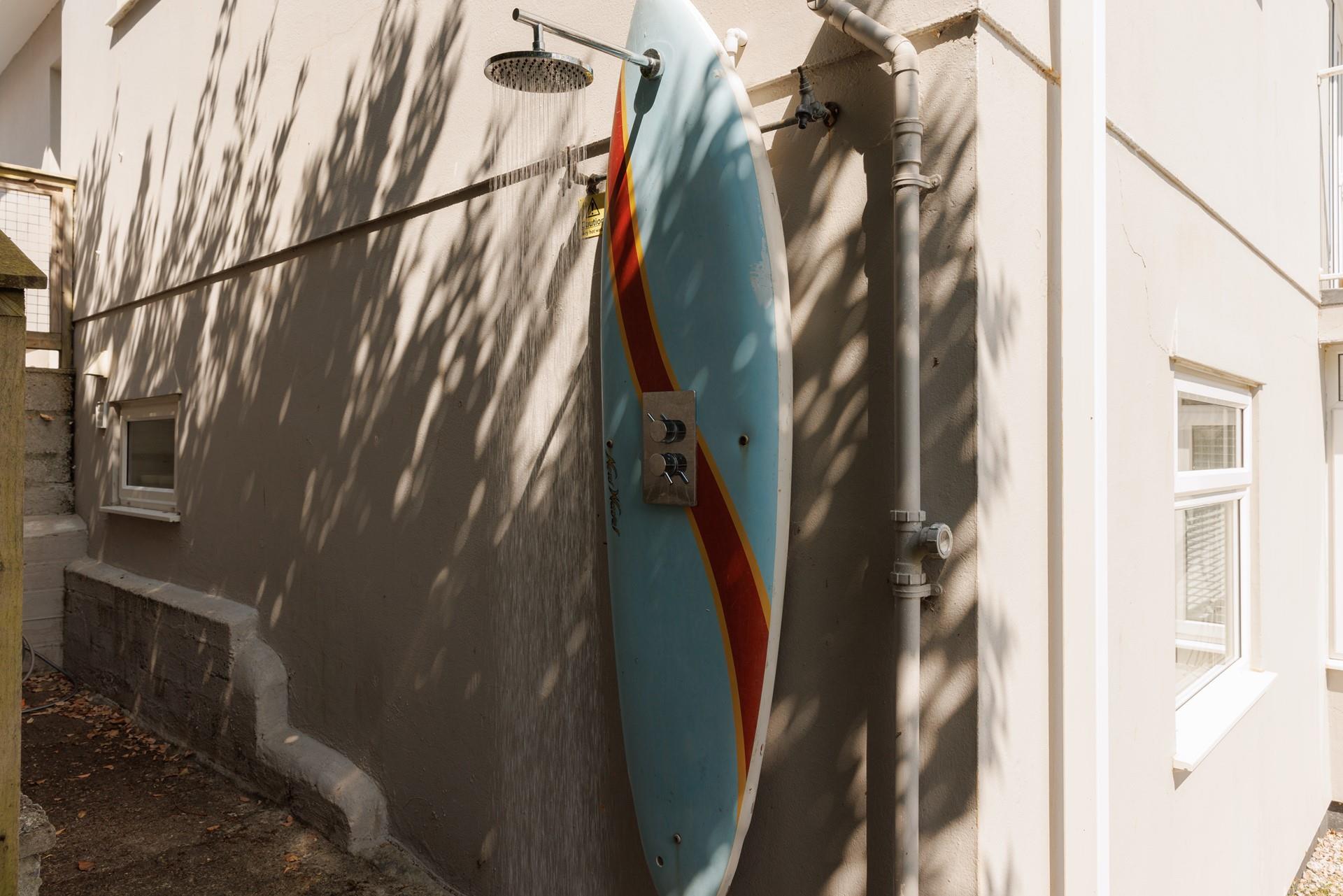 Wash off sandy wetsuits under the handy outside shower.