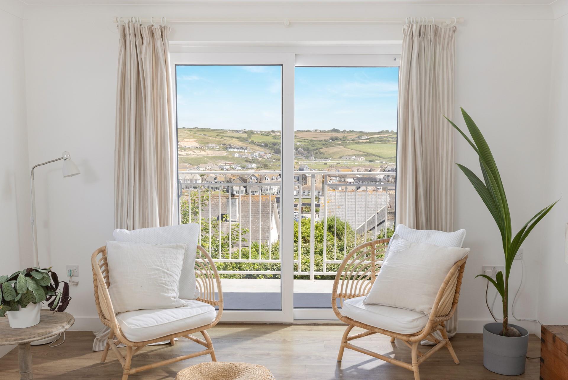 Sit in the window and enjoy the views of Perranporth beach.