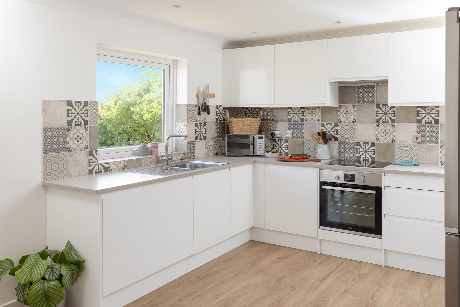 The kitchen features a modern and sleek design, plenty of space for cooking a feast!