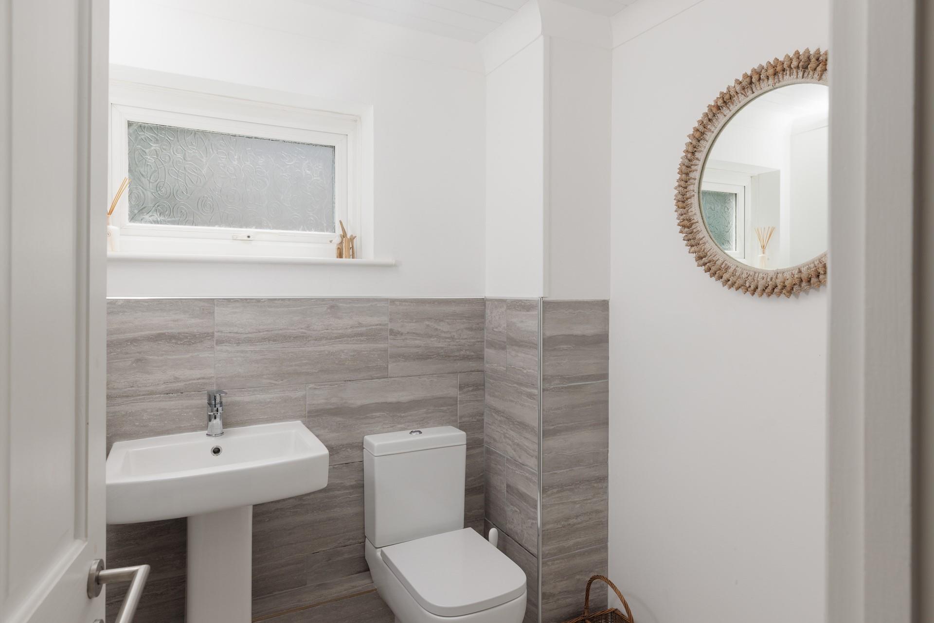 The cloakroom has a WC and a basin.