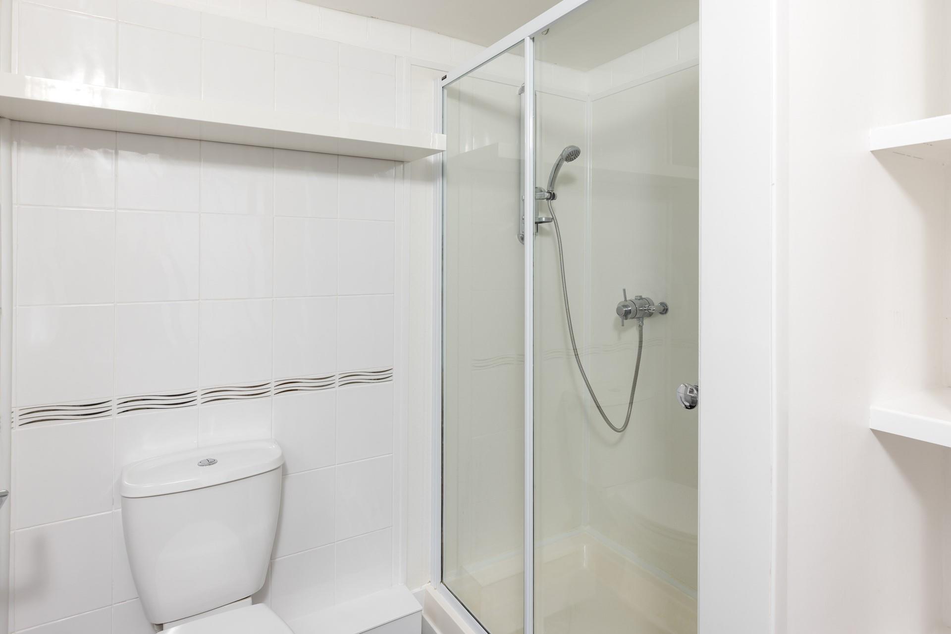The family bathroom has an enclosed shower.