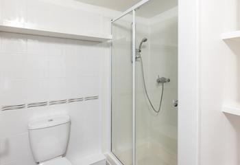 The family bathroom has an enclosed shower.