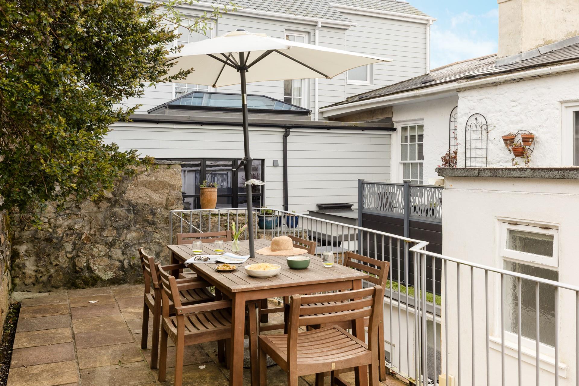 Unwind in the courtyard, dining al fresco in the Cornish sunshine.