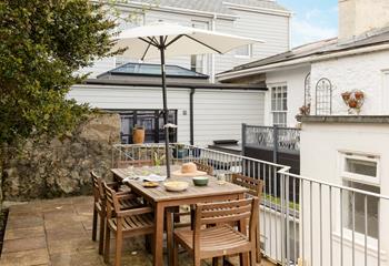 Unwind in the courtyard, dining al fresco in the Cornish sunshine.