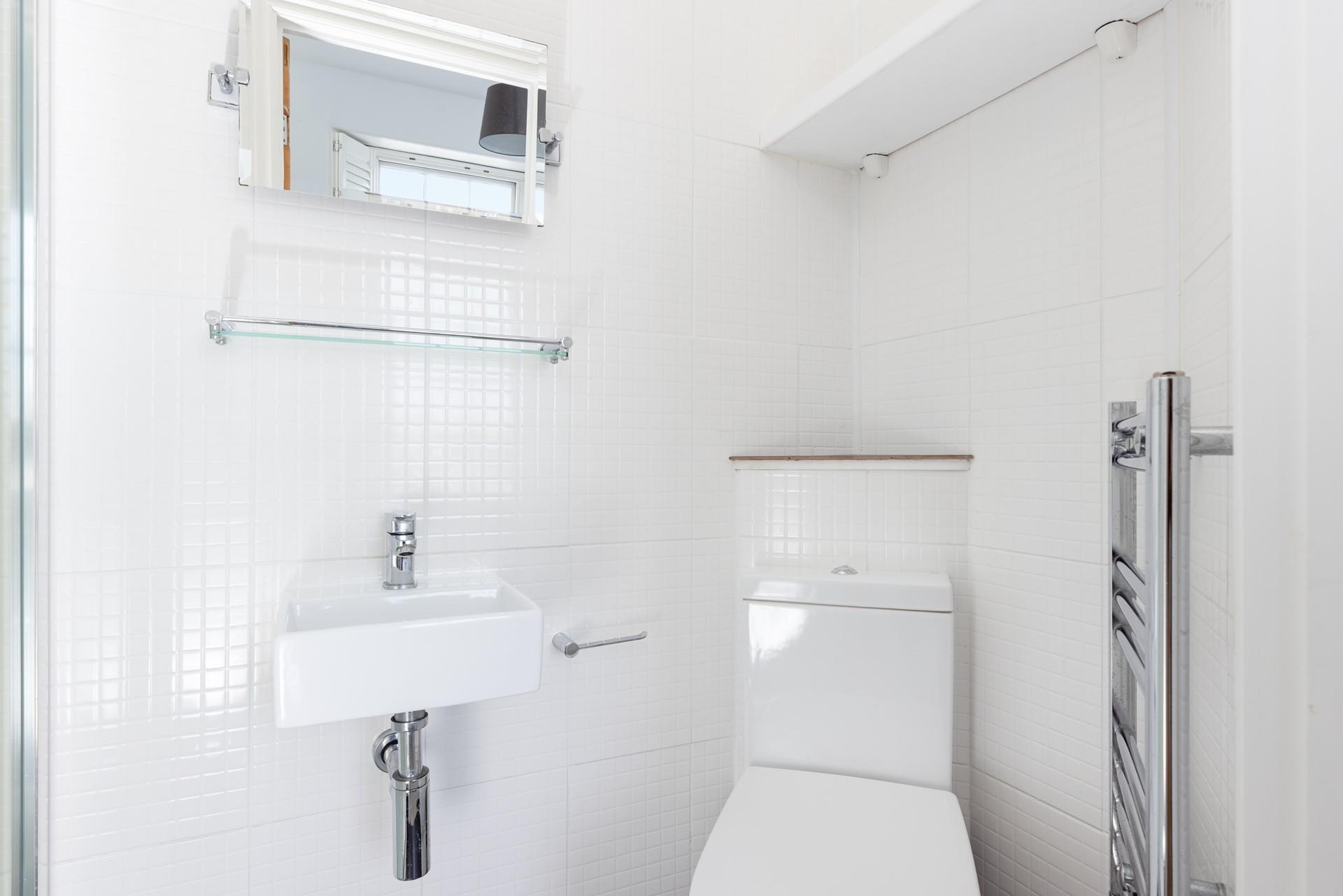 The second en suite offers another warming towel rail.