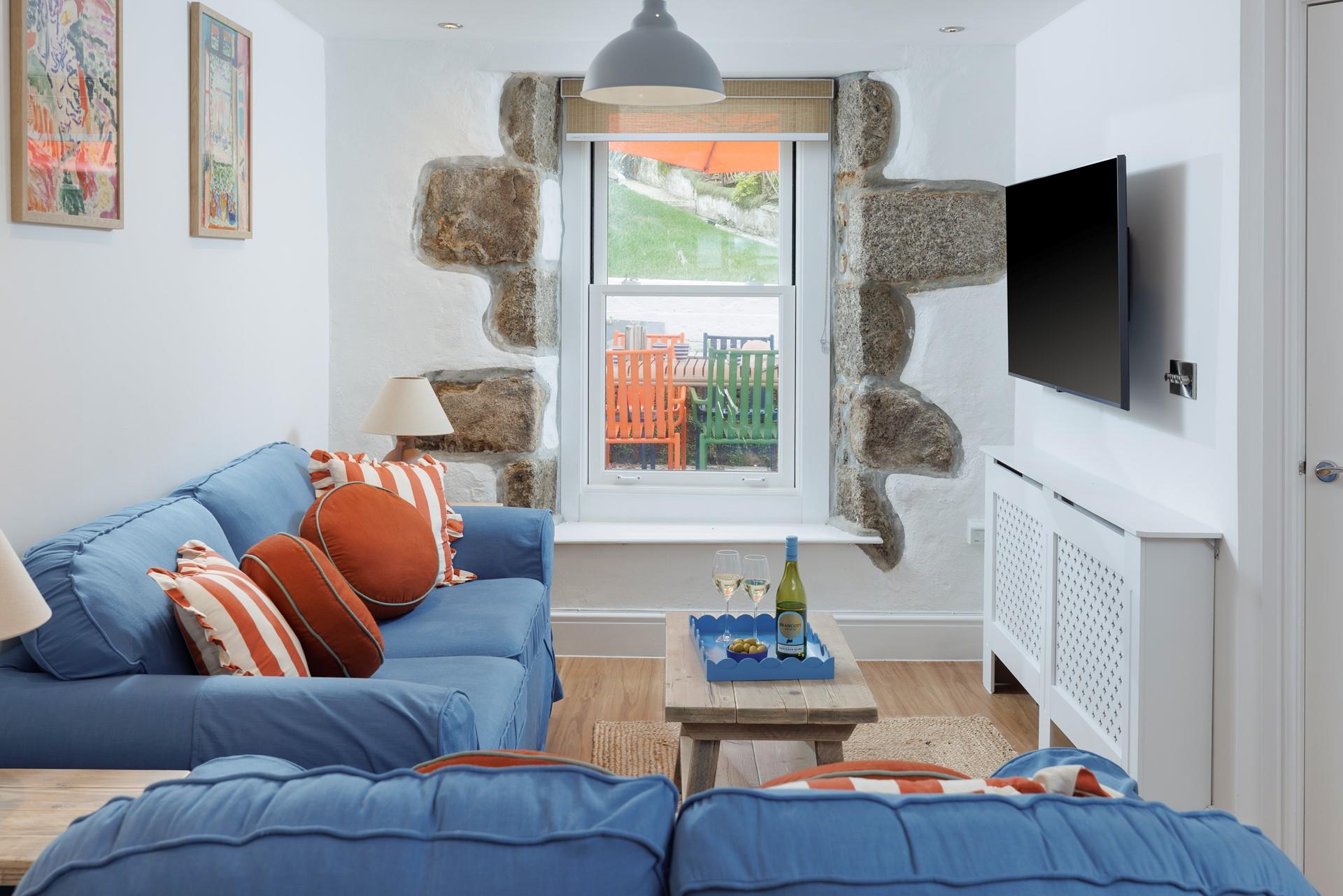 Tastefully decorated, the sitting room is a cosy space to relax and unwind.