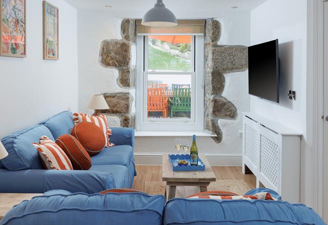 Tastefully decorated, the sitting room is a cosy space to relax and unwind.