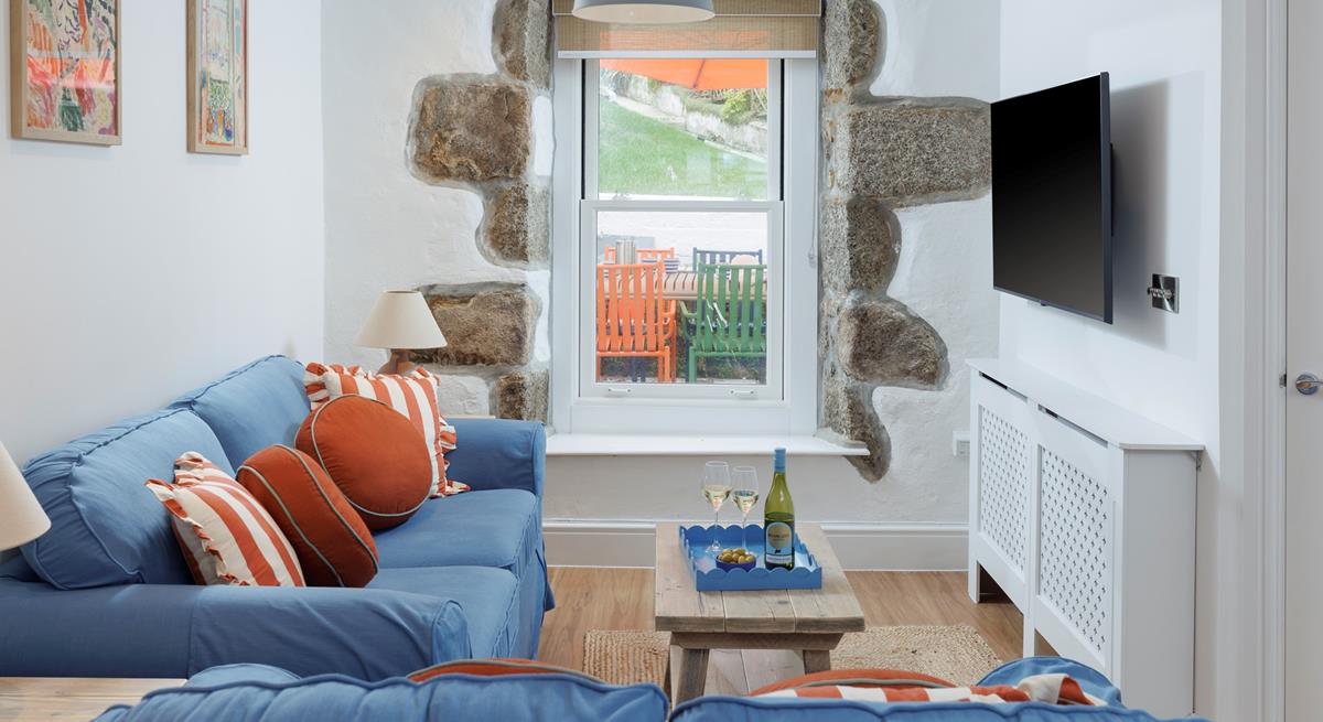 Tastefully decorated, the sitting room is a cosy space to relax and unwind.