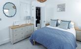 This cosy bedroom is decorated with coastal blues. - Thumbnail Image