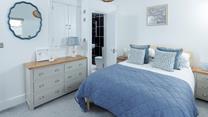 This cosy bedroom is decorated with coastal blues.