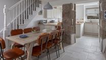 The dining table seats 8 comfortably, ideal for the family to enjoy meals together.