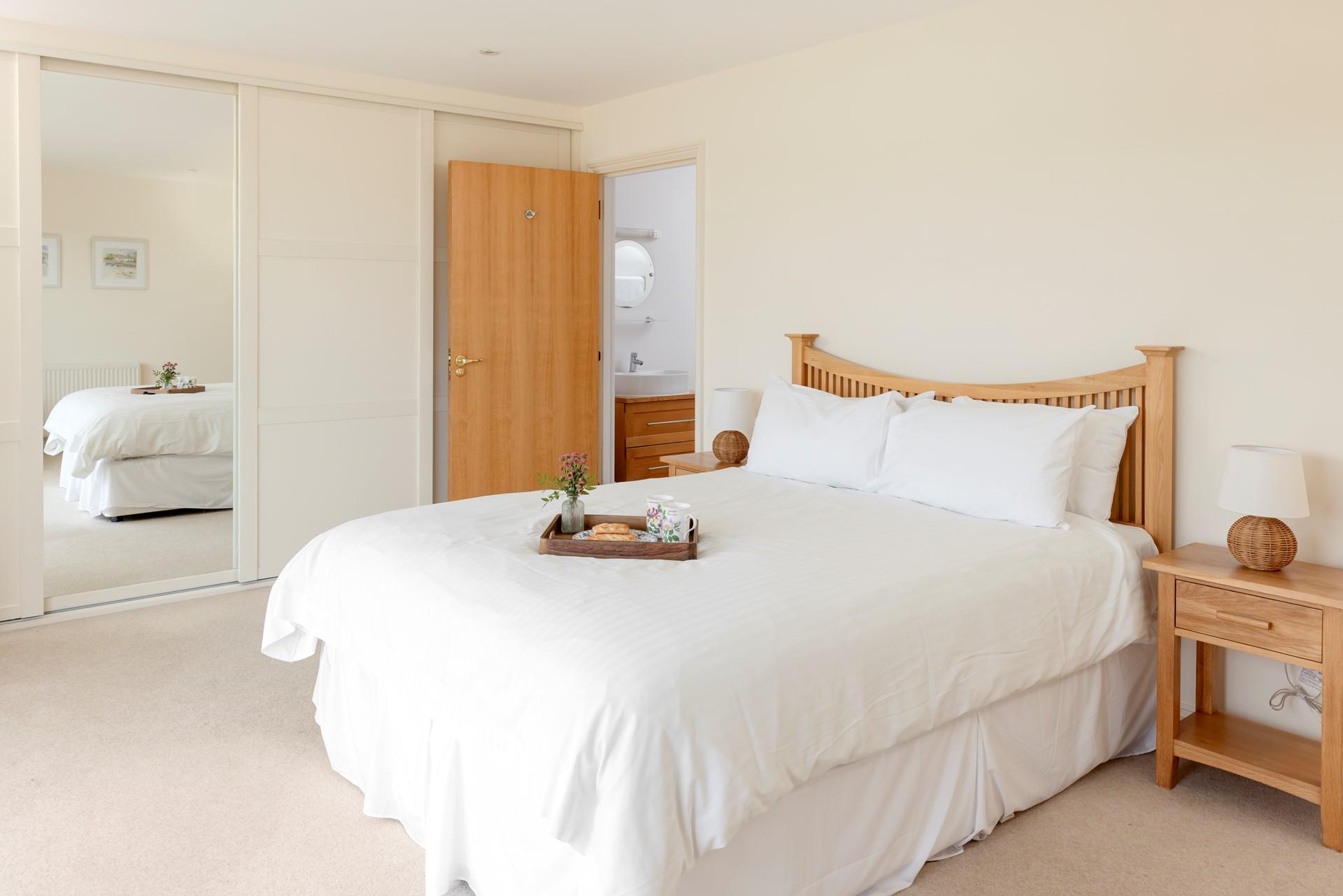 The bedroom has ample wardrobe space and an en suite.