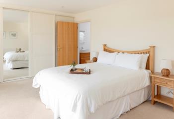 The bedroom has ample wardrobe space and an en suite.