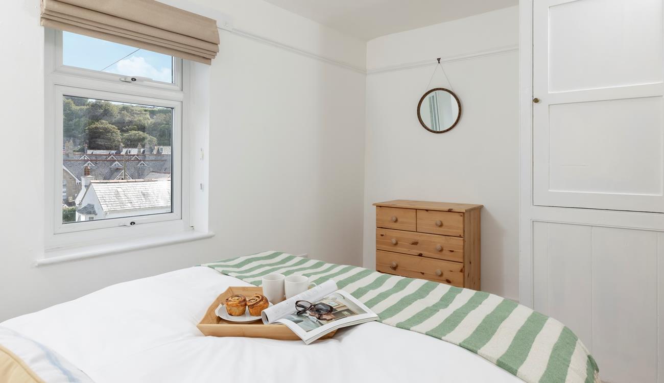 The master bedroom offers views across the rooftops.