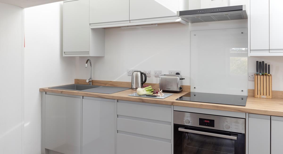 The kitchen is compact and well-equipped.