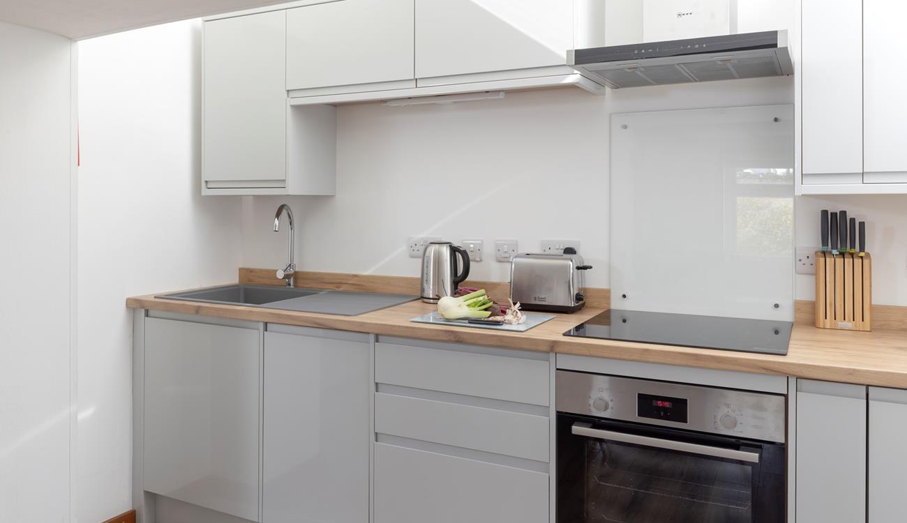 The kitchen is compact and well-equipped.