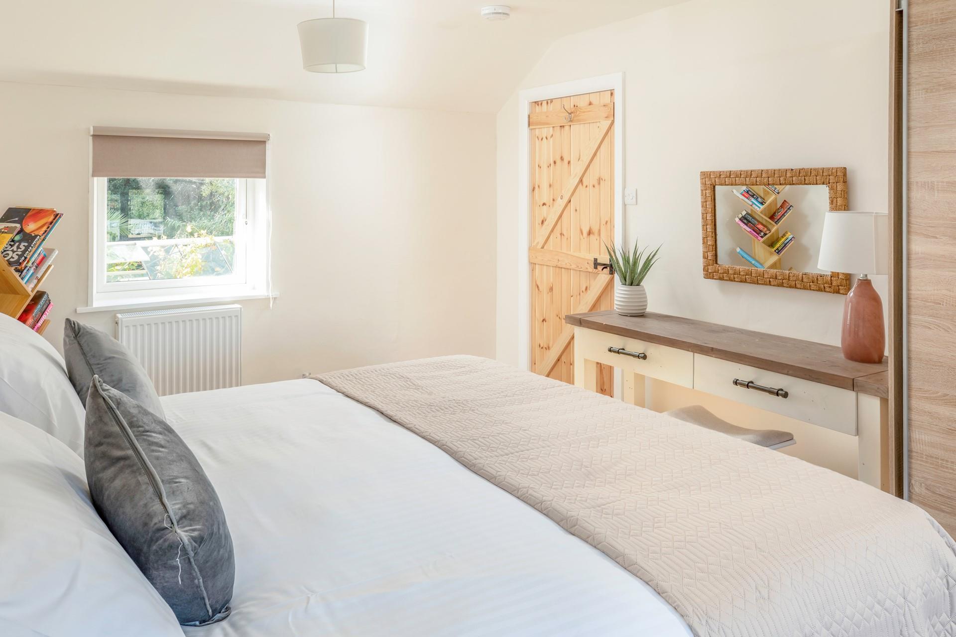 The spacious king size bed offers a relaxing night's sleep.