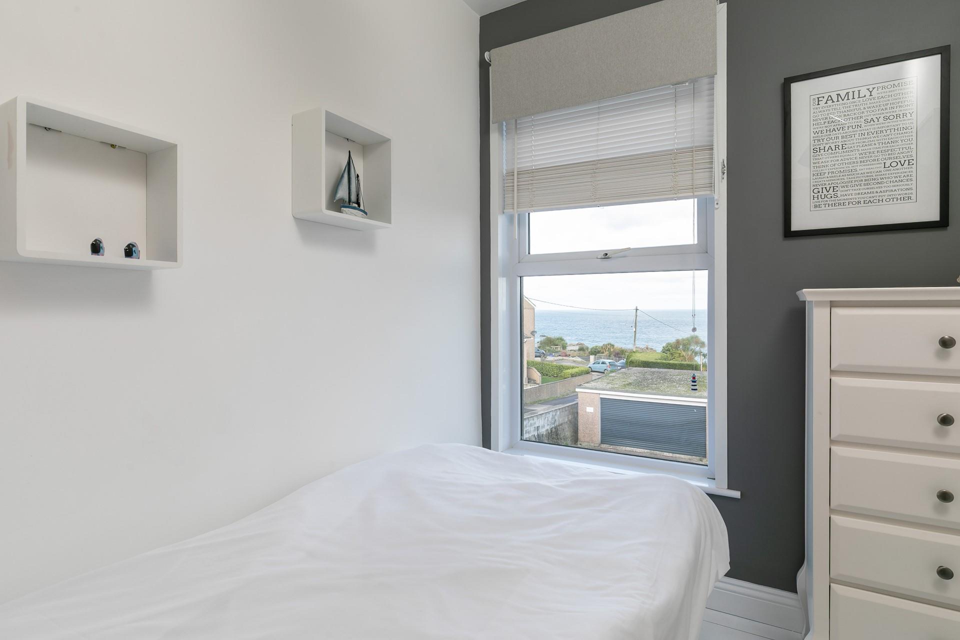 The single room provides an additional space for guests to enjoy a relaxing night's sleep.