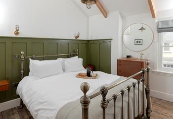 Bedroom 2 is tastefully decorated with earthy tones.