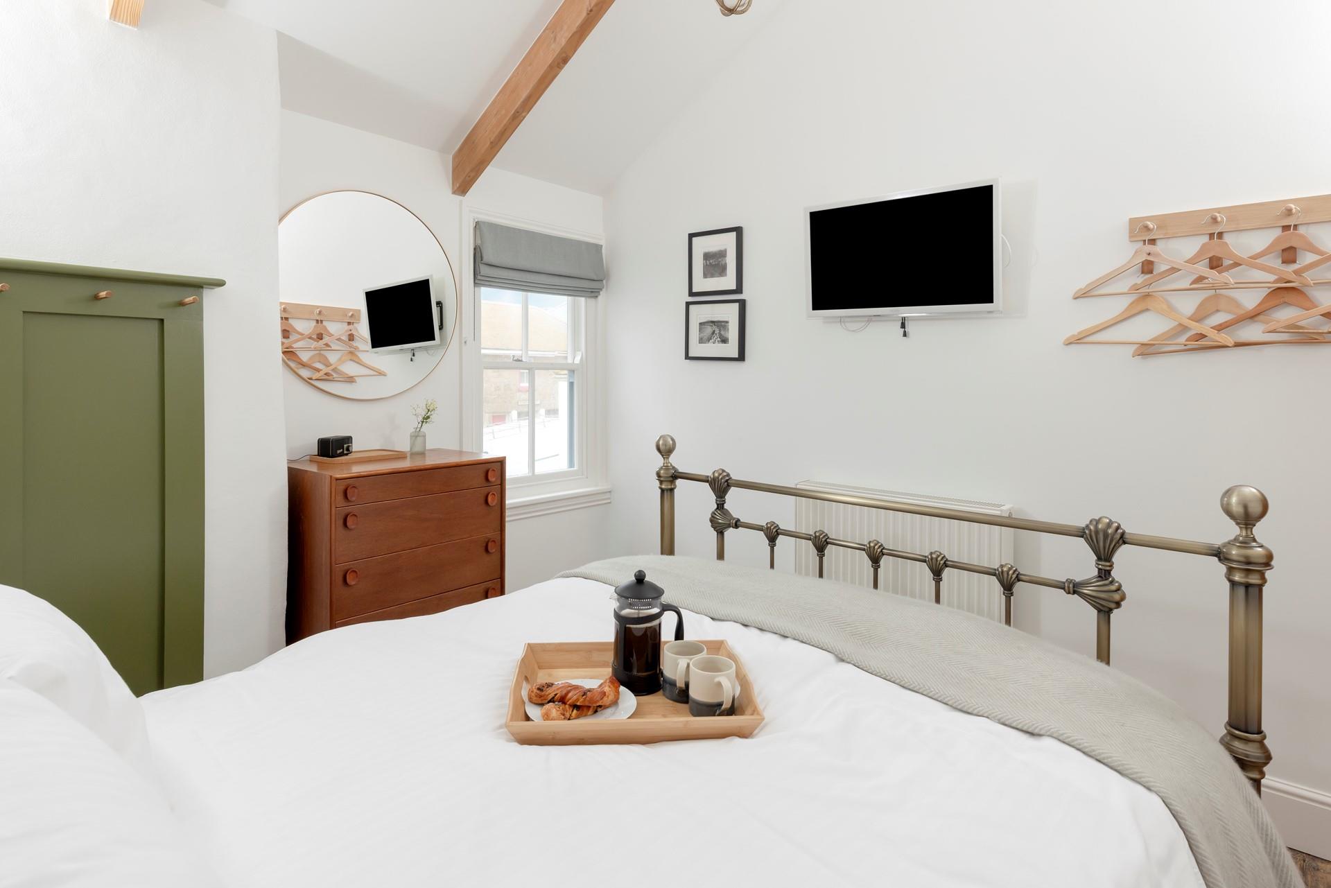 The spacious king size bed provides a relaxing night's sleep.