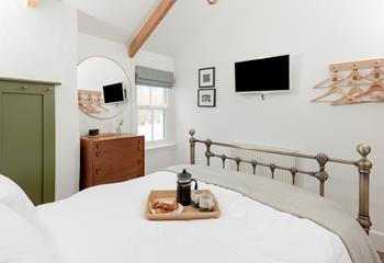 The spacious king size bed provides a relaxing night's sleep.