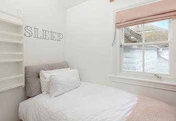 Bedroom 3 is decorated with pastel tones and is a cosy space to relax.