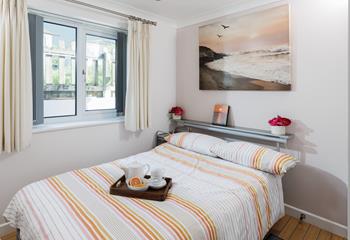 Bedroom 1 takes inspiration from the golden tones of a Cornish sunset.