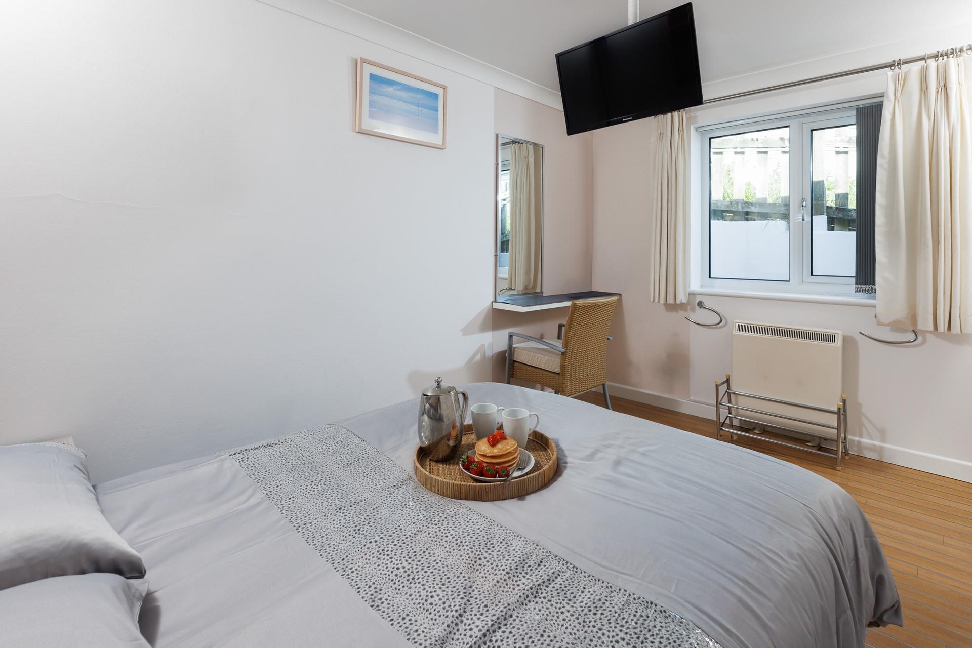Bedroom 2 has a handy sink, dressing table and wardrobe storage.