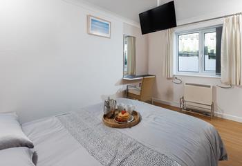 Bedroom 2 has a handy sink, dressing table and wardrobe storage.