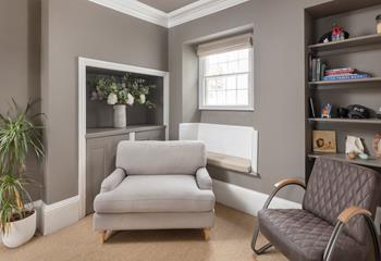The stylish sitting room has space for the whole family to relax.