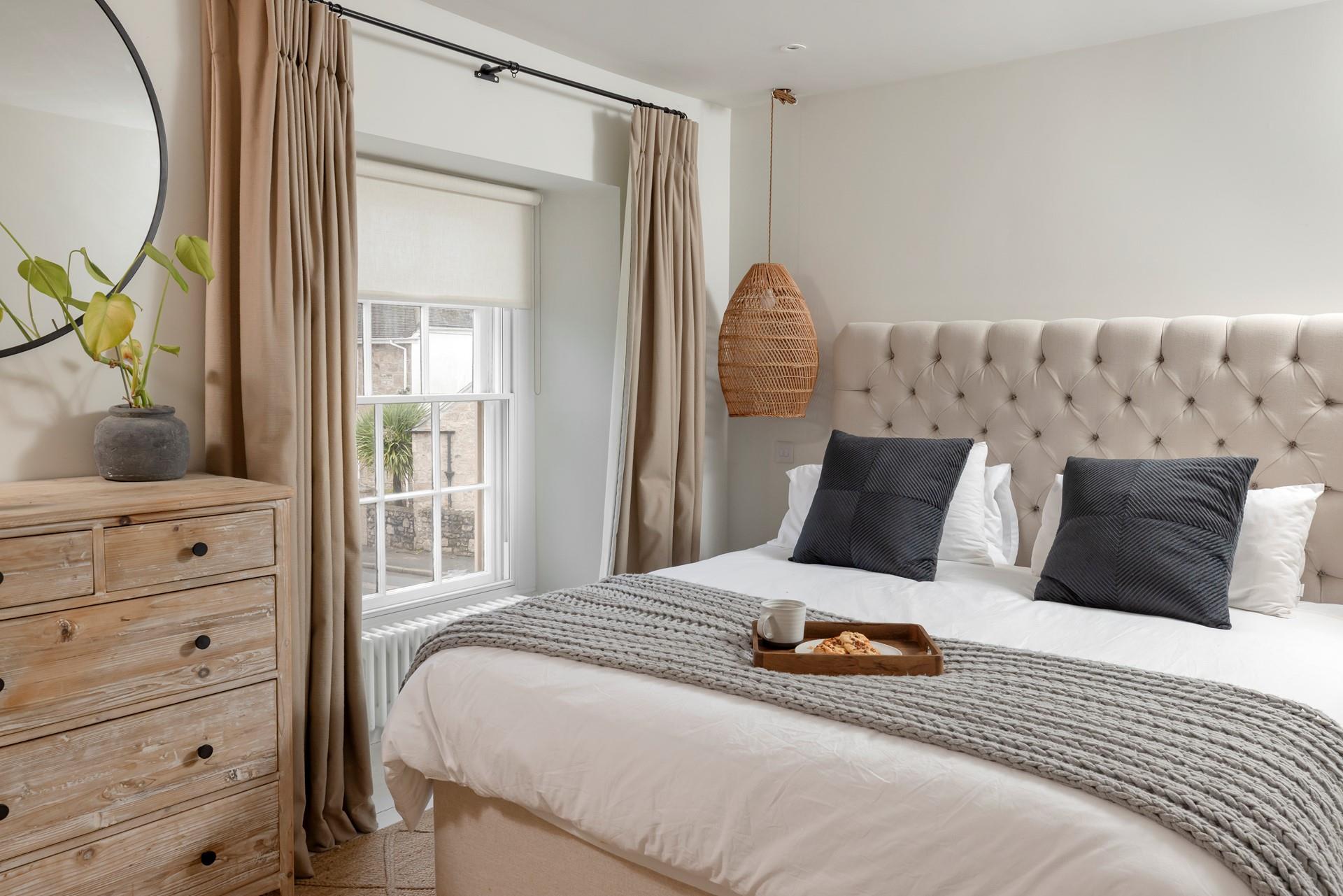 Bedroom 1 is decorated with calming pastel tones.