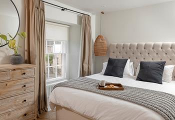 Bedroom 1 is decorated with calming pastel tones.