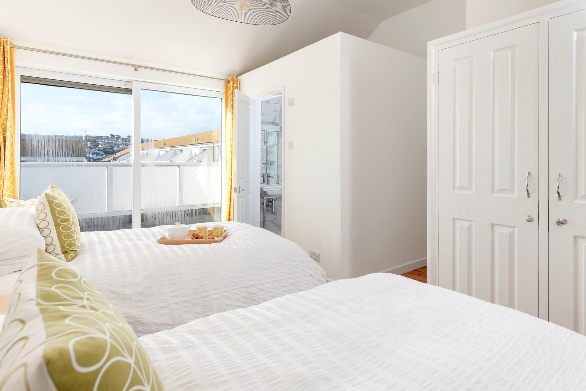 The apartment features two single beds and a sofa bed.