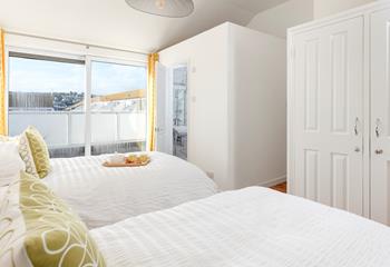 The apartment features two single beds and a sofa bed.