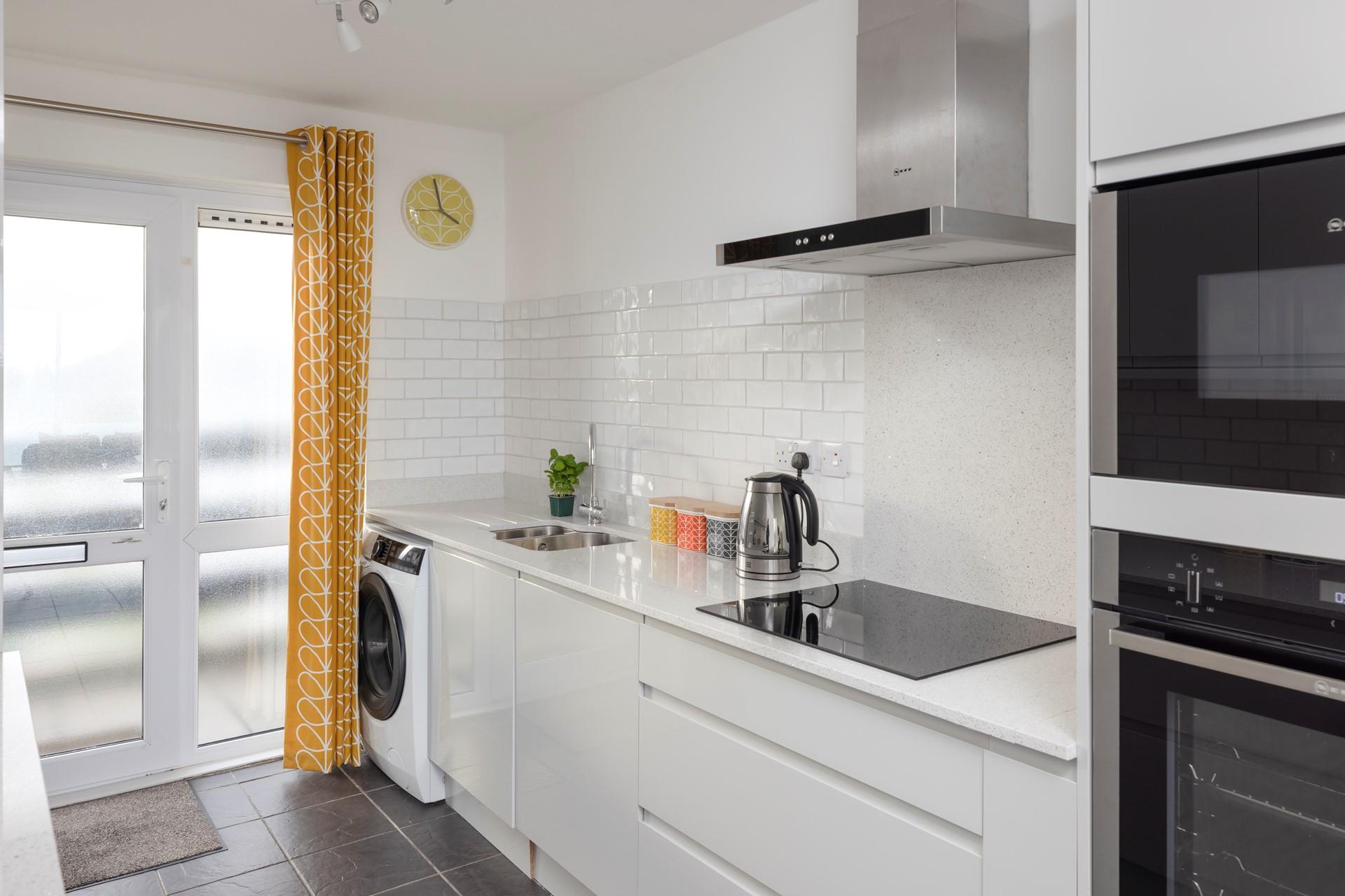 The modern and sleek kitchen has plenty of space to cook up a storm.