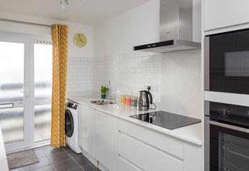 The modern and sleek kitchen has plenty of space to cook up a storm.