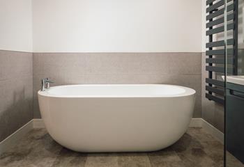 The free-standing bath offers a luxurious place to unwind after long days.