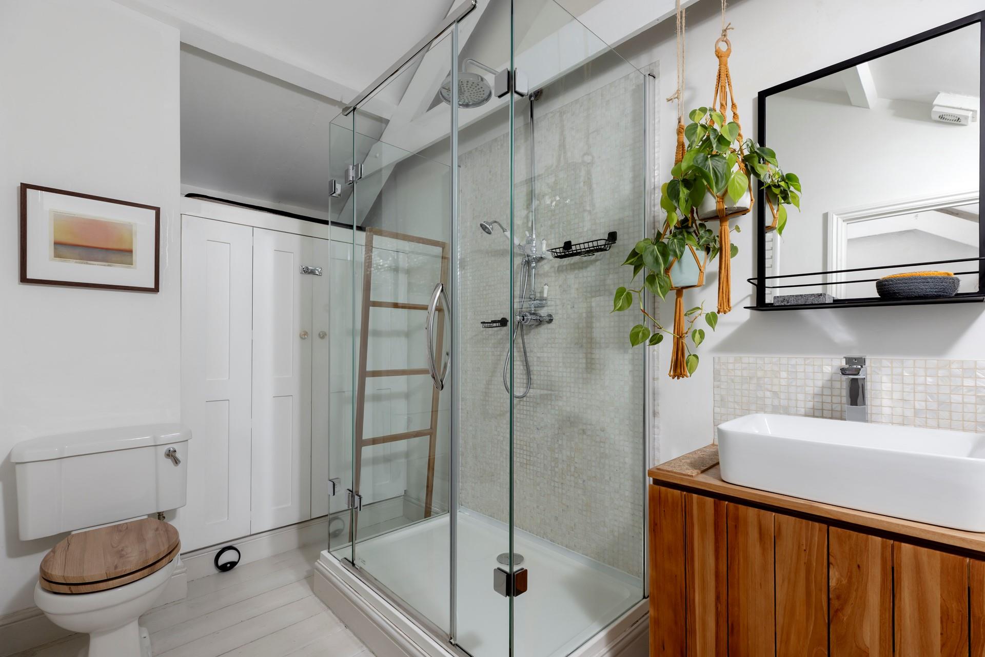 The bathroom blends modern amenities with stylish decor.
