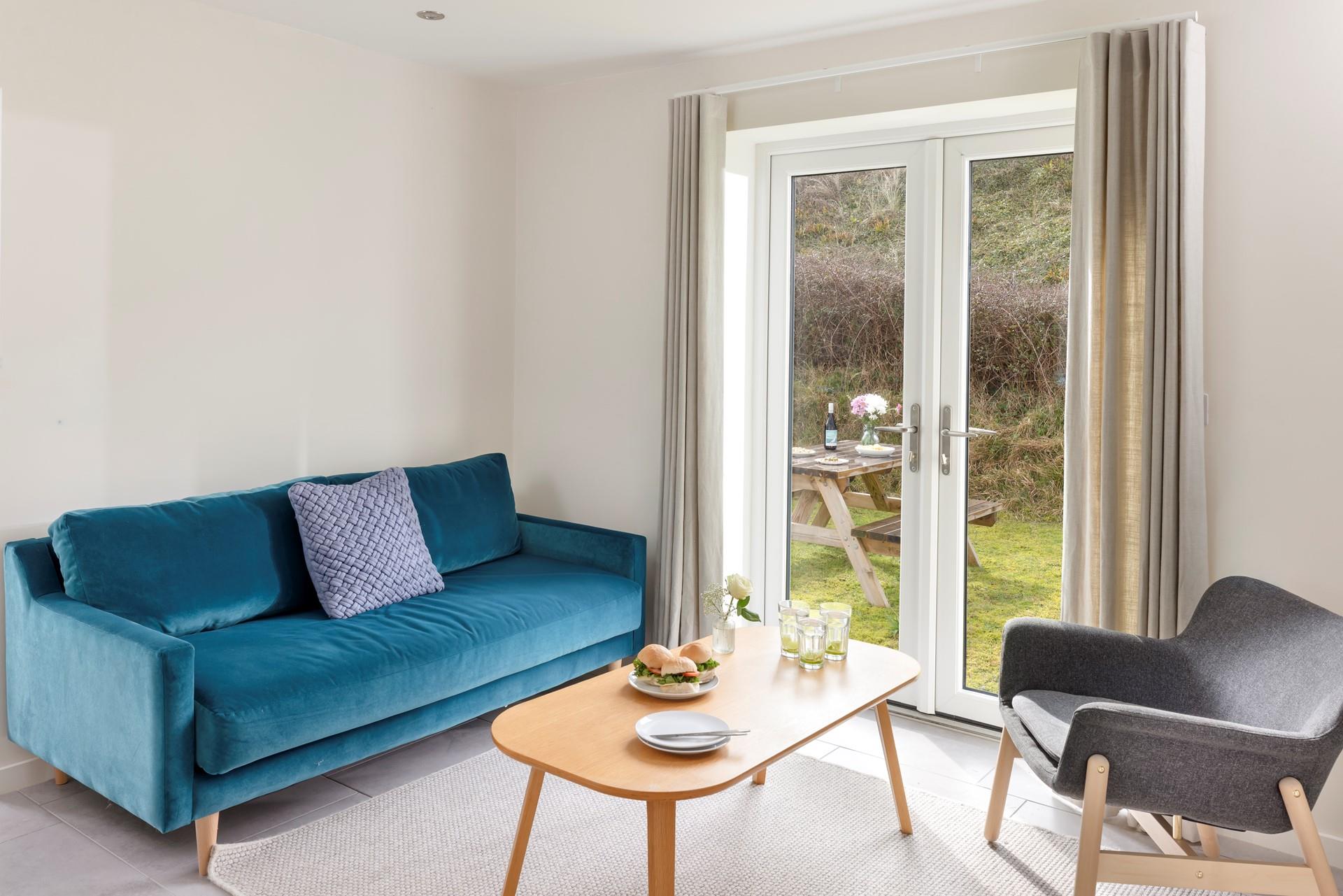 Relax in the sitting room as the summer breeze drifts in from the garden.