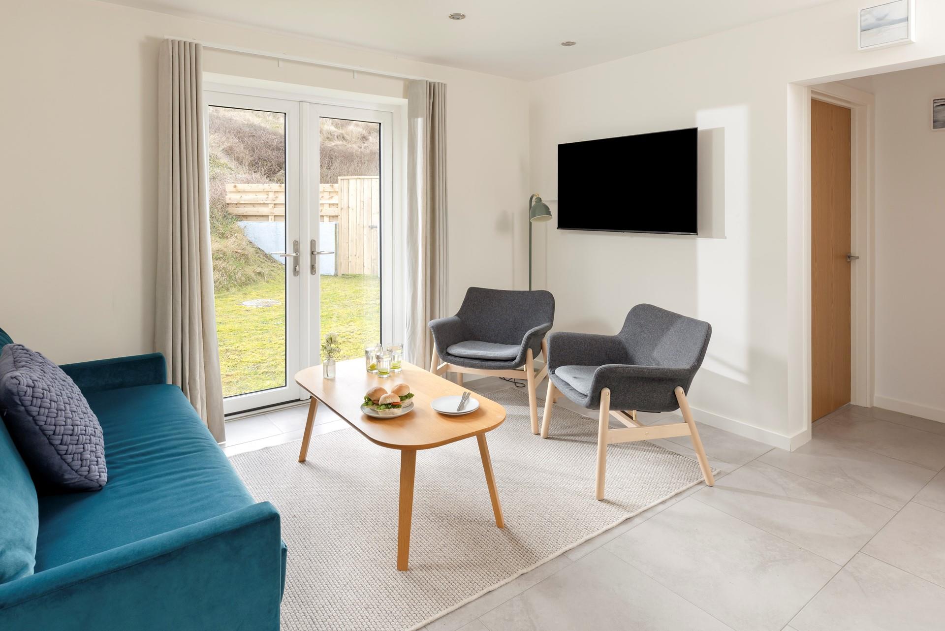 The sitting room is bright and airy with modern furnishings.