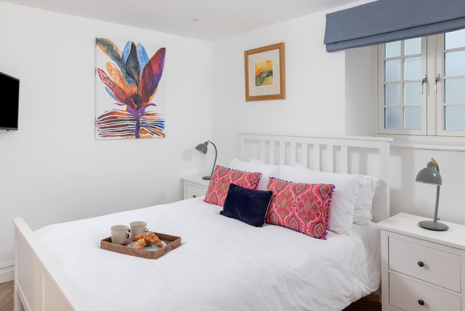 The bedrooms feature colourful artwork and soft furnishings.