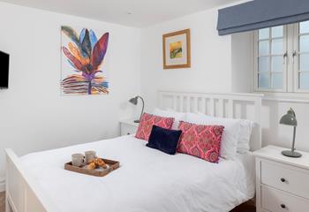 The bedrooms feature colourful artwork and soft furnishings.