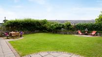 The enclosed garden is a secure outdoor haven for the whole family to enjoy. 