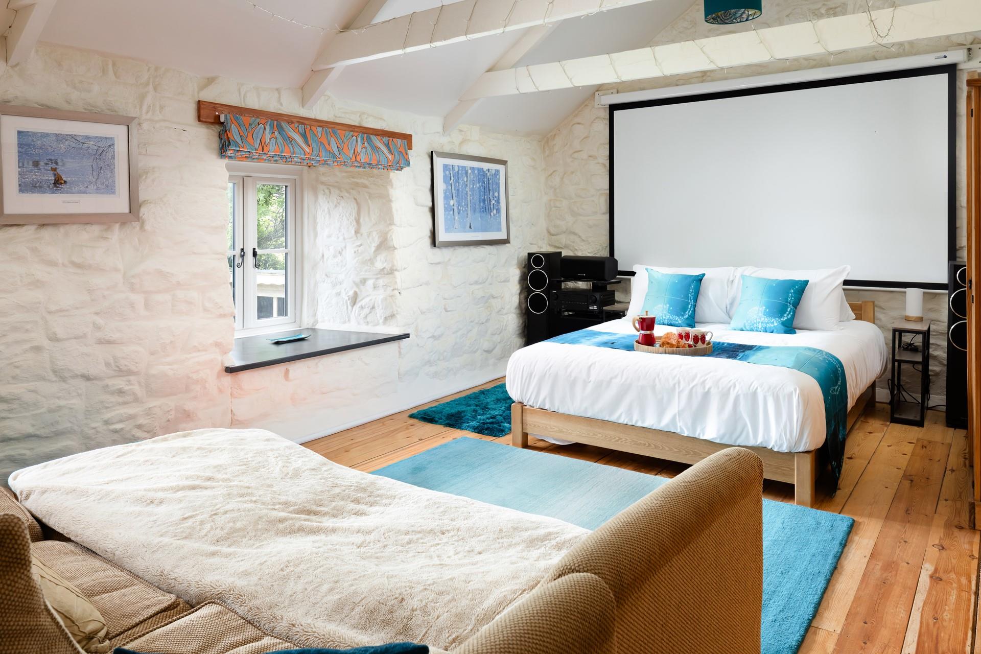 Dim the lights, sink into the sofa, and enjoy a movie night under a cosy blanket in bedroom 3. 
