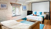 Dim the lights, sink into the sofa, and enjoy a movie night under a cosy blanket in bedroom 3. 