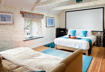 Dim the lights, sink into the sofa, and enjoy a movie night under a cosy blanket in bedroom 3. 