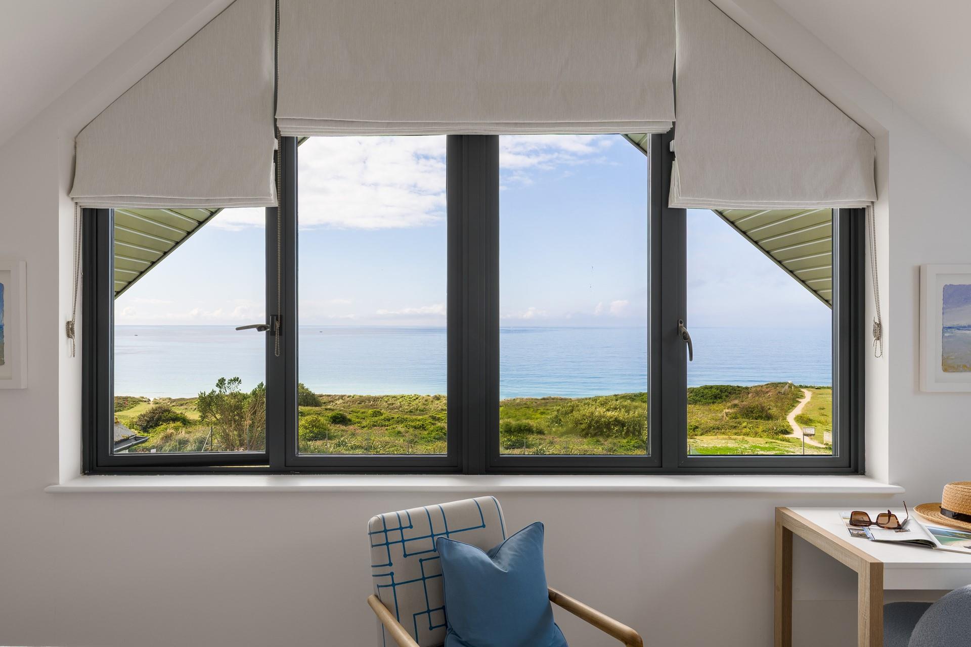 Open the blinds each morning to see the sun shining on the sea.