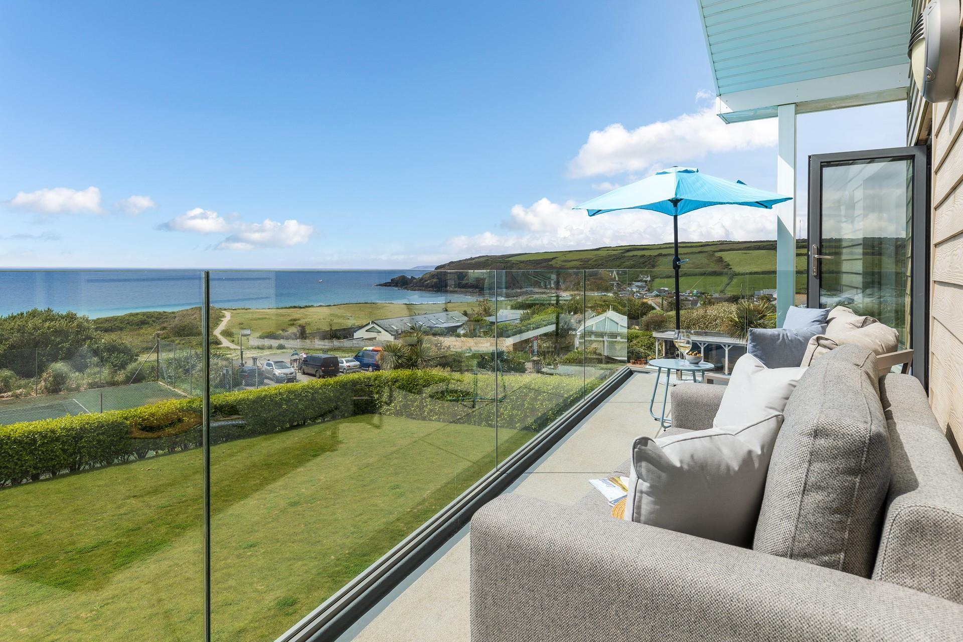 Snuggle up on the outdoor sofa and watch the sun set over the ocean.